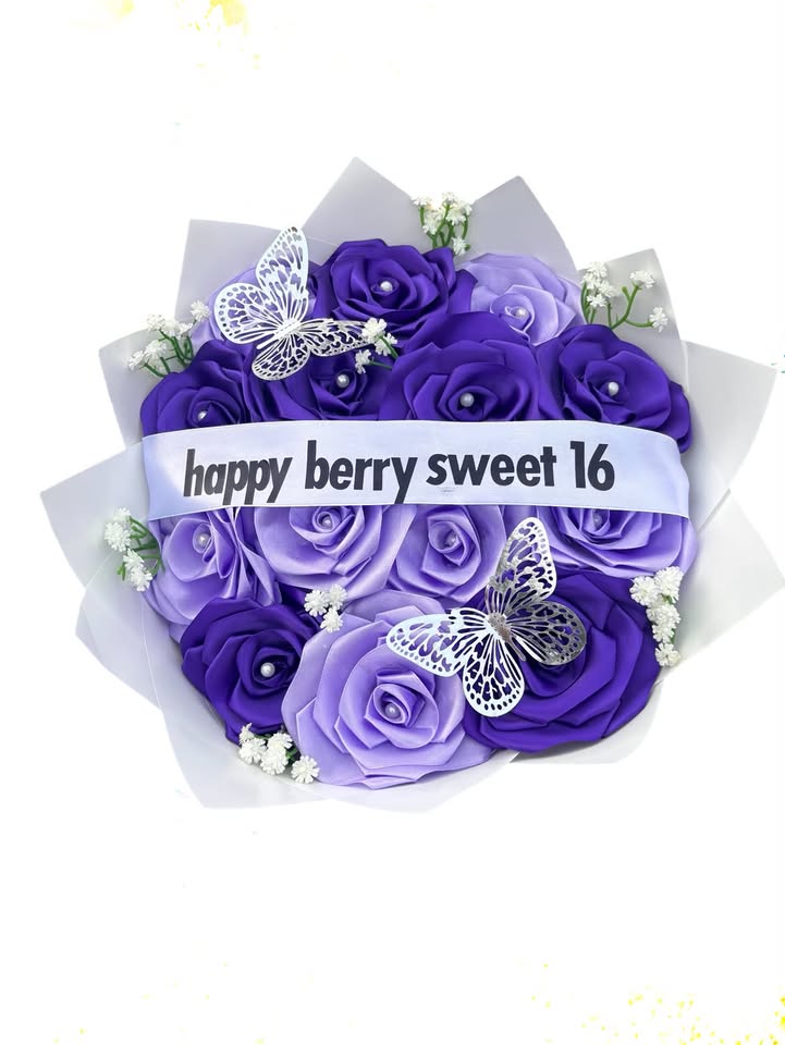 Purple and lavender foam roses with silver butterflies and a happy berry sweet 16 ribbon