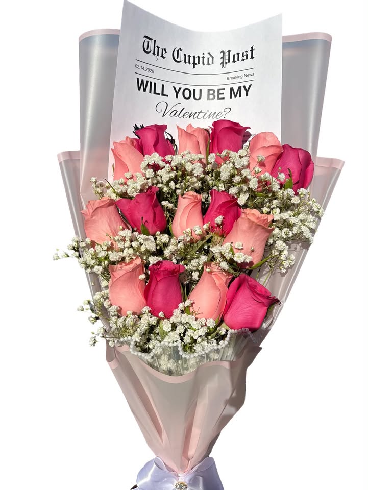 Pink and hot pink roses with baby's breath and a Will You Be My Valentine newspaper card